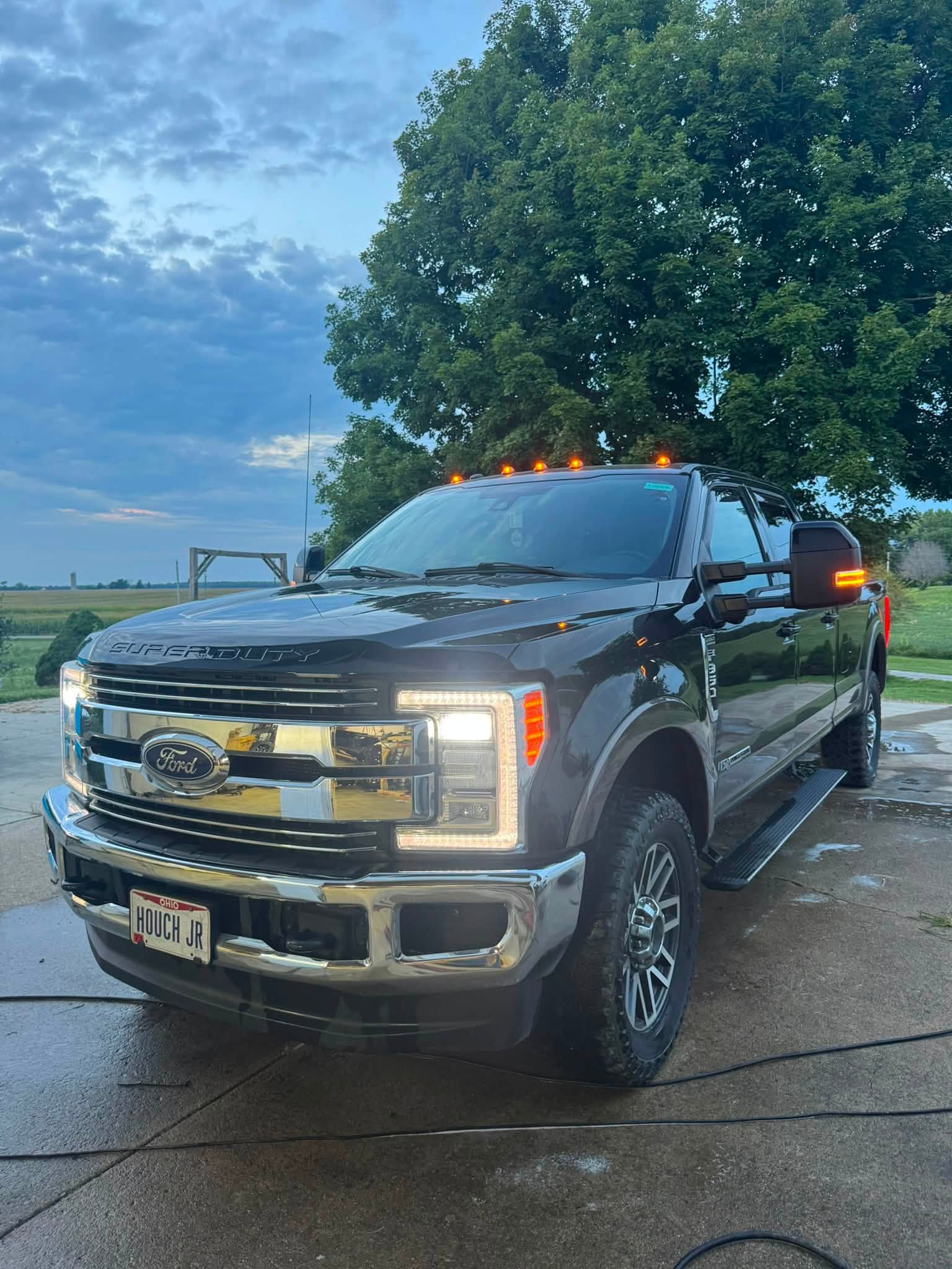 Ford F-250 with headlights on after a full detail